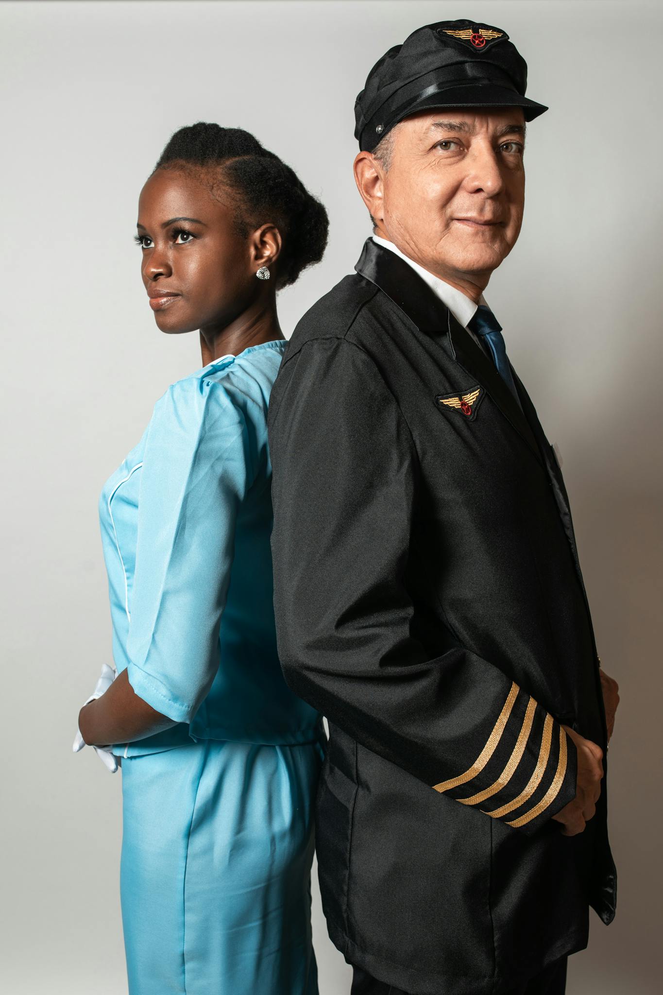 Side-by-side studio portrait of a pilot and flight attendant showcasing professionalism.